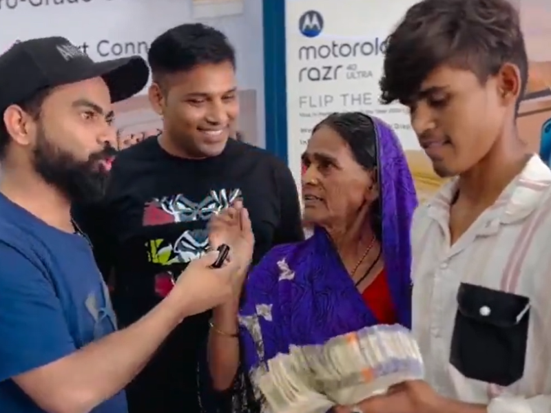 Two Indian men interview an Indian mother and her teenage son