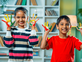 Two Indian siblings showing off their painted palms