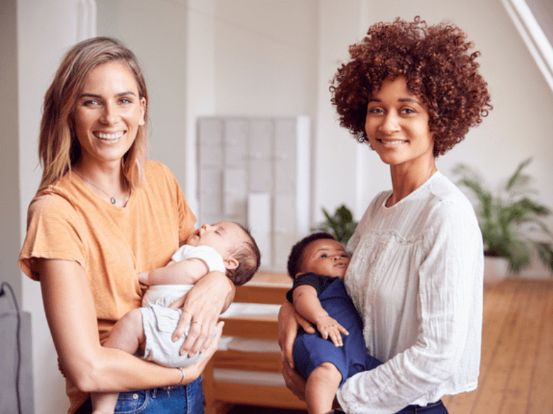 Two mothers carrying their babies