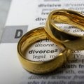 Two rings places on top of dictionary with the word divorce written on it