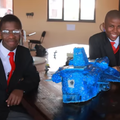 Two students from Adams College in KZN sit with their robot invention