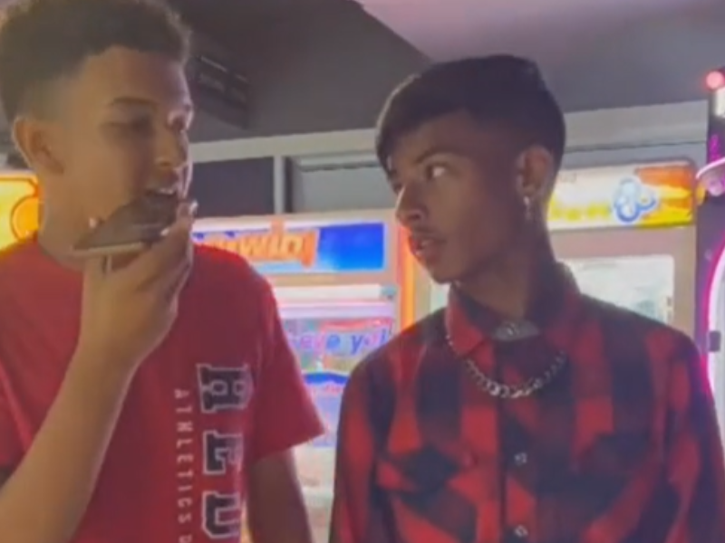 Two teenage boys talking to each other at the game area in Pavilion Shopping Centre