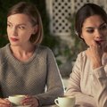 Two upset female friends sitting in cafe