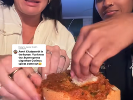 Two women enjoy a mutton curry bunny chow together