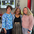Two women in powerlifting standing with Carol Ofori in the East Coast Radio studios