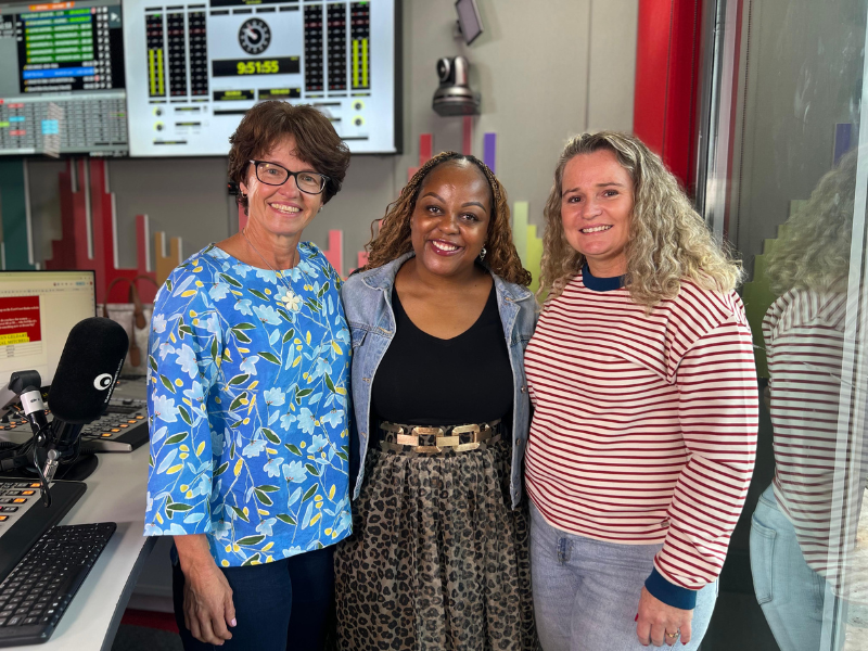 Two women in powerlifting standing with Carol Ofori in the East Coast Radio studios