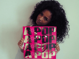 Tyla holding a  vinyl copy of her A-POP album