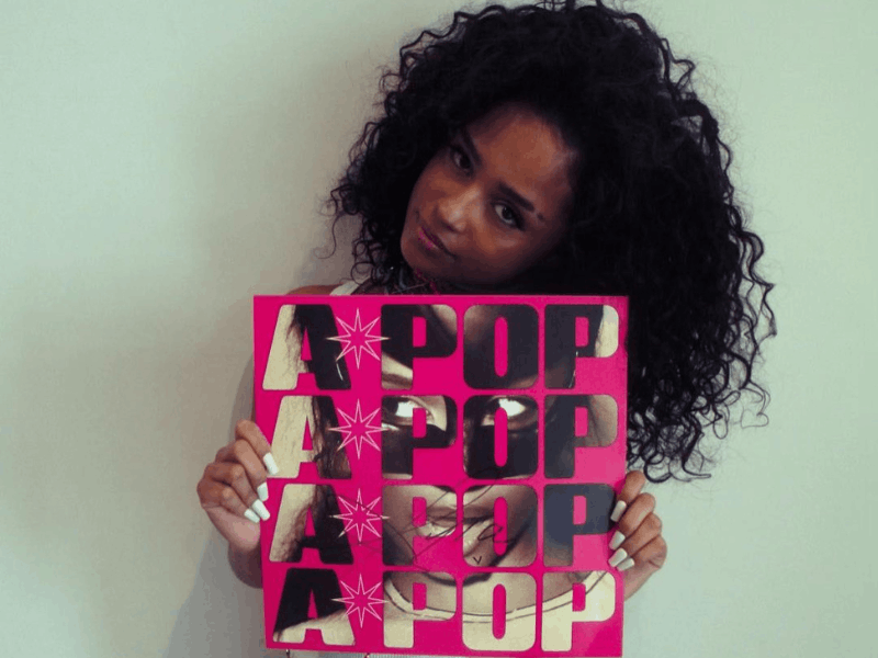 Tyla holding a  vinyl copy of her A-POP album