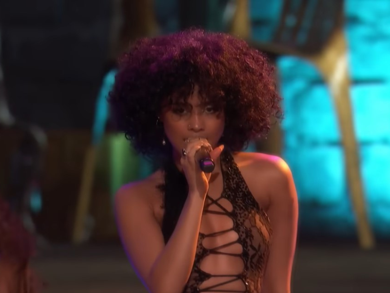 Tyla holds a mic while singing on 'The Voice'