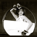 Tyla posing with a Chanel hula-hoop bag