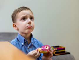 UPSET CHILD WITH DONUT