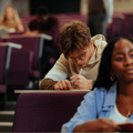 University students taking notes during lecture in a lecture hall