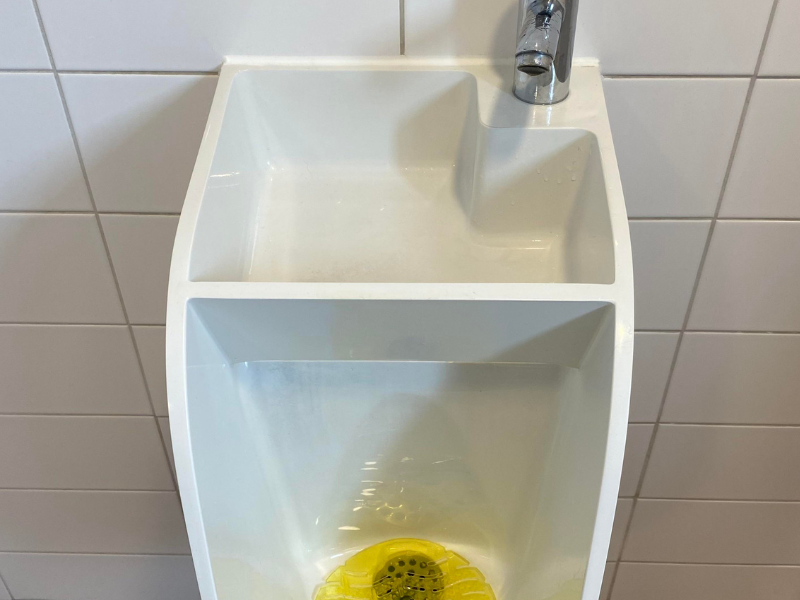 Urinal with a basin at the top