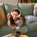 WOMAN LISTENING TO MUSIC ON COUCH