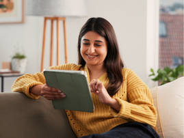 WOMAN ON TABLET READING EBOOK