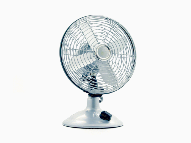 White desk fan on white table