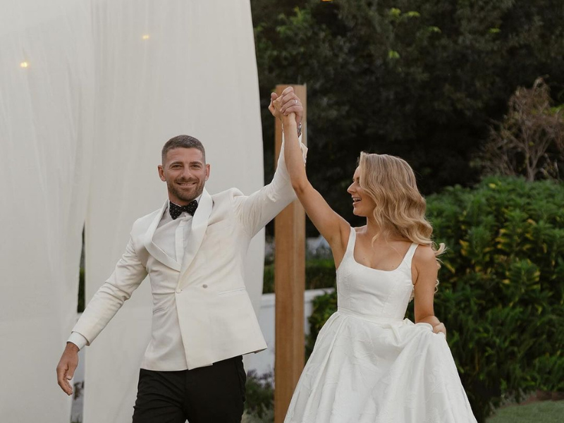 Willie le Roux and his wife holly hold hands on their wedding day