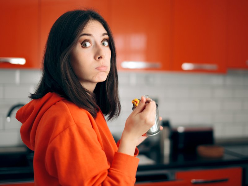 Woman Eating From a Can