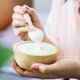 Woman eating plain yoghurt iStock