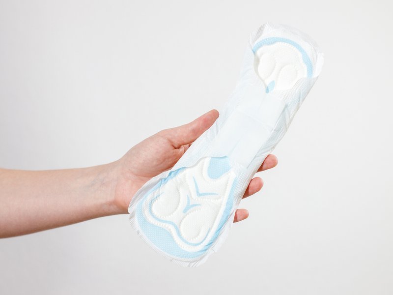 Woman holding a menstrual pad