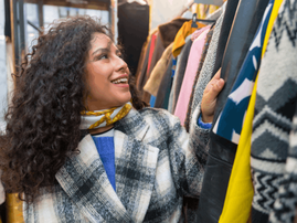 Woman looking at clothes in a vintage secondhand store