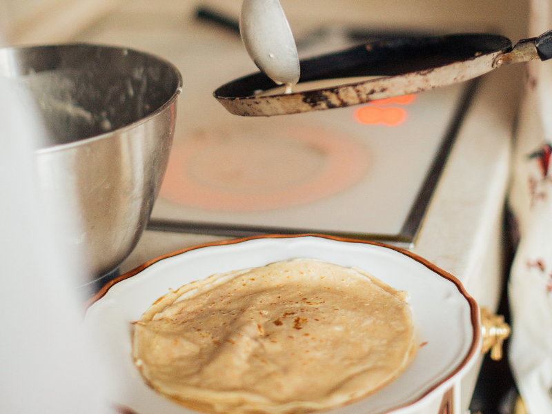 Woman preparing crepes on a pan