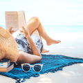 Woman reading a book on the beach