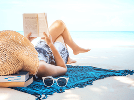 Woman reading a book on the beach