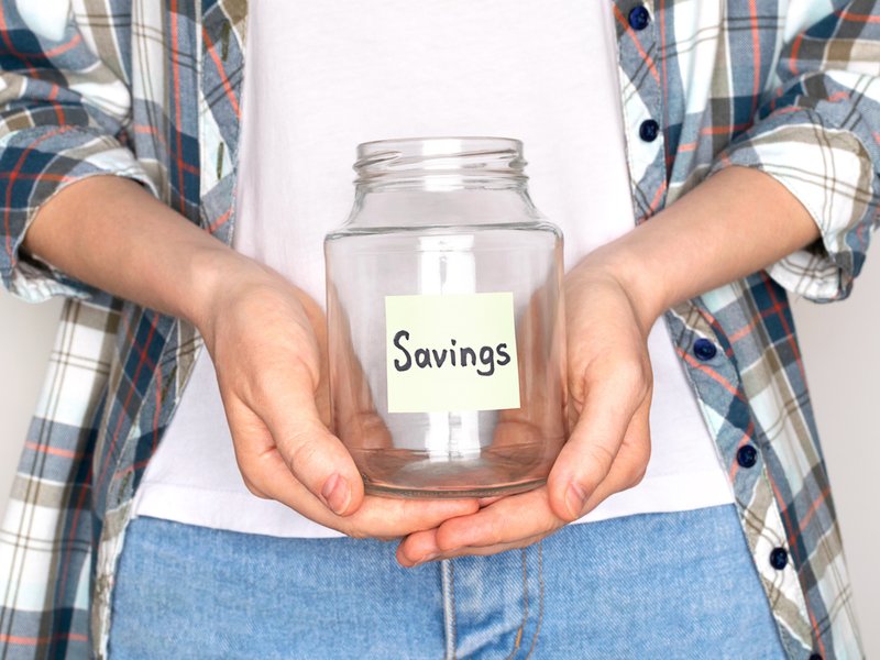 Woman saving money/ iStock