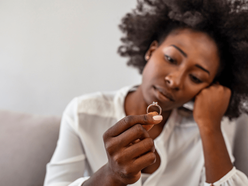 Sad woman staring at a ring