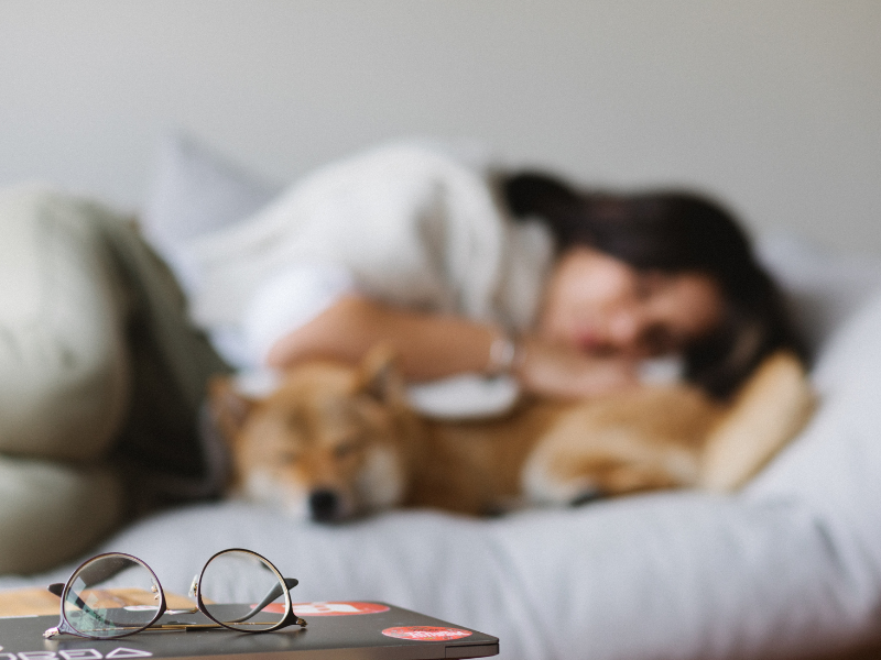 Woman sleeping with her dog