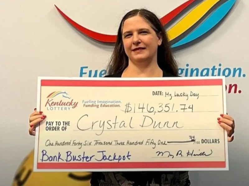 Woman standing with her winning lottery check