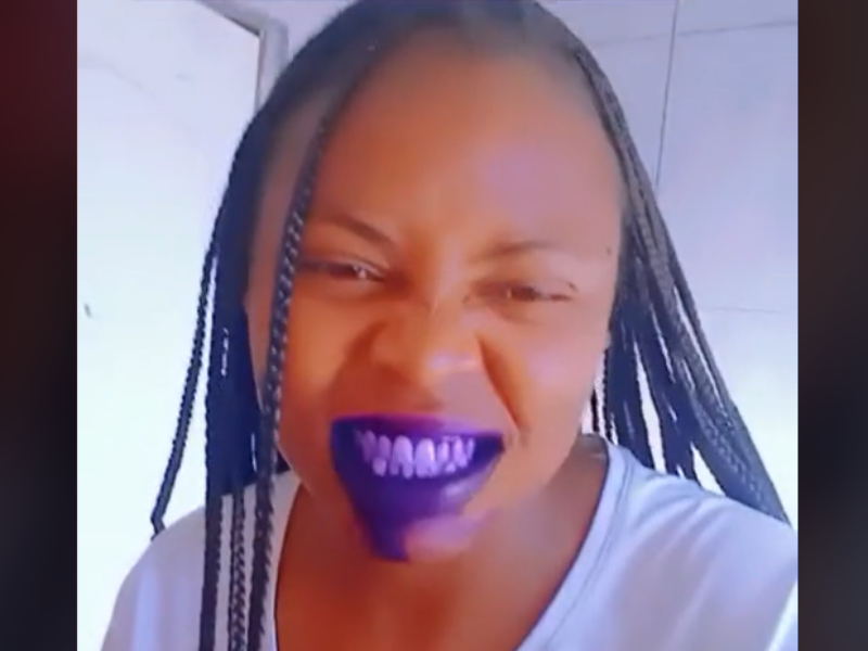 Woman with braids showing off her purple mouth