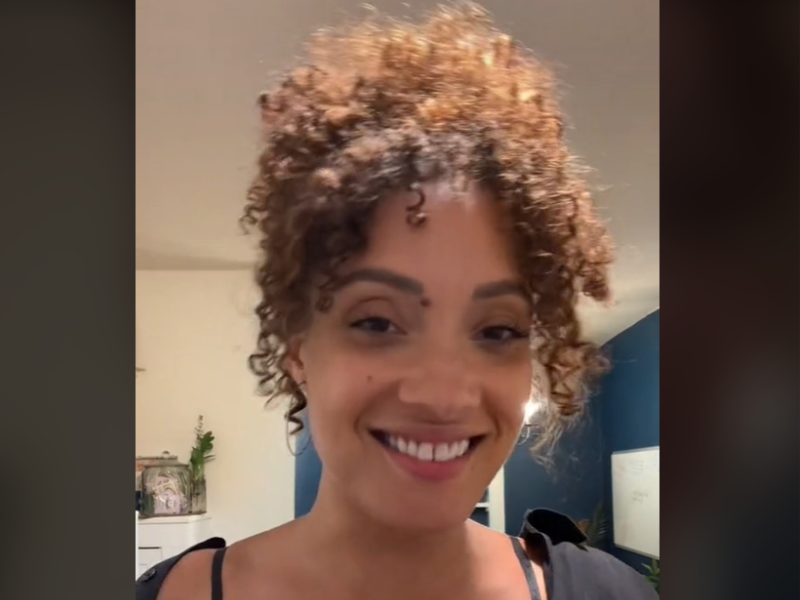 Woman with curly hair smiling