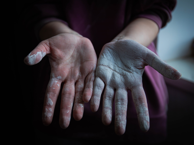 Woman's hands covered in white paint