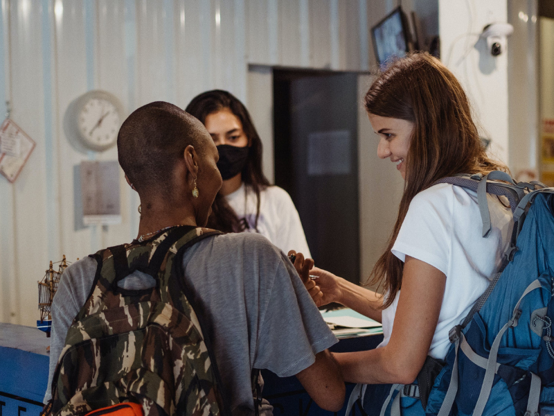 Women checking in at a hotel or backpackers inn