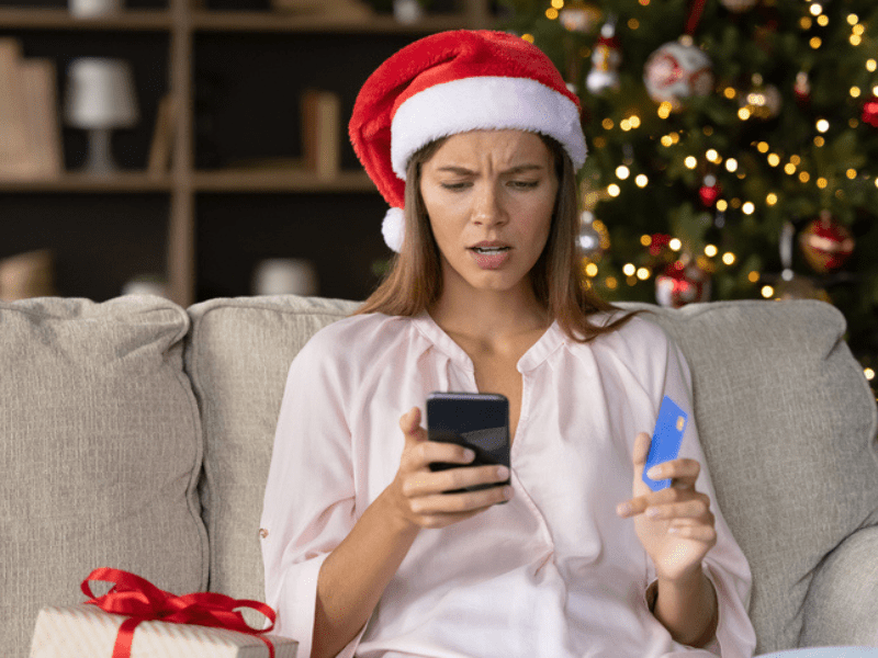 Worried concerned woman in Christmas Santa hat