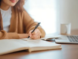 YOUNG WOMAN STUDYING