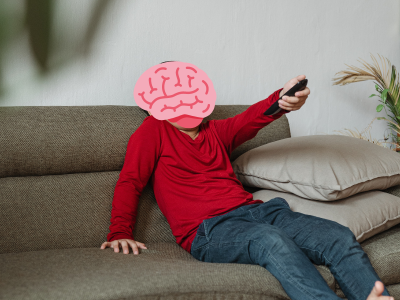 Young boy resting at home watching TV