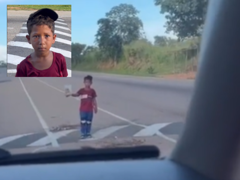 Young boy selling food on the side of the road