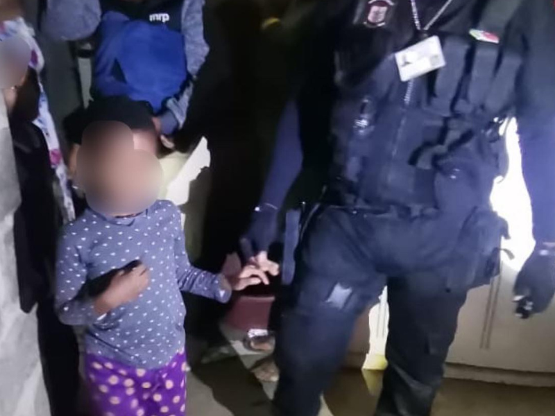 Young girl walking with a Security official