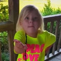 Young girl with her hands pointing up at someone