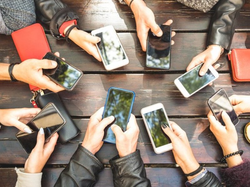 Young people holding their cellphones