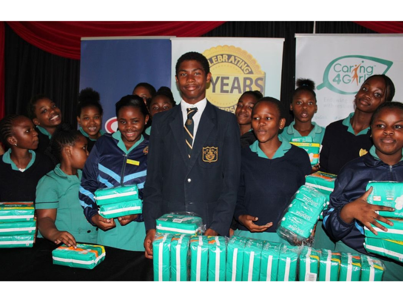 Young schoolboy standing with schoolgirls