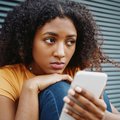 Young woman using cellphone to get help