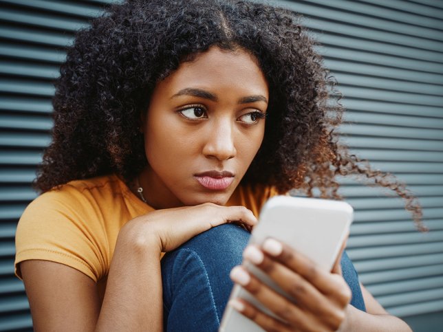 Young woman using cellphone to get help