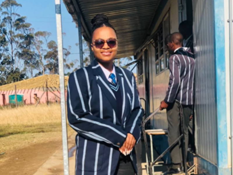 Young woman wearing a school uniform and sunglasses