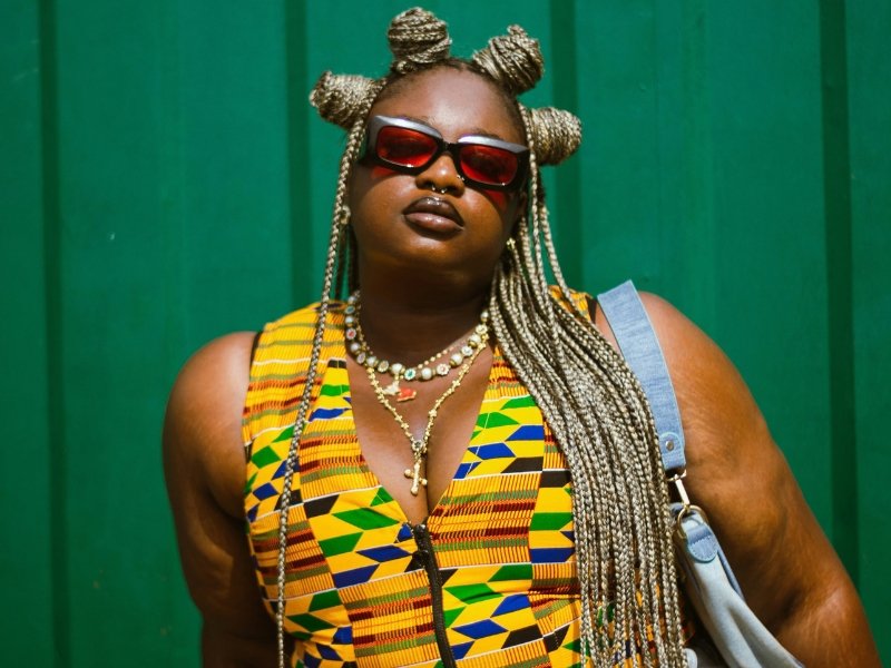 Young woman wearing top that has traditional fabric
