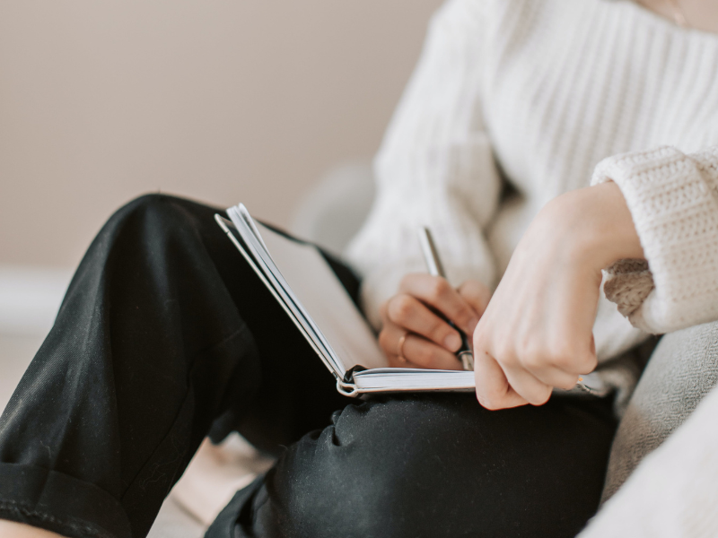Young woman writing in her notebook