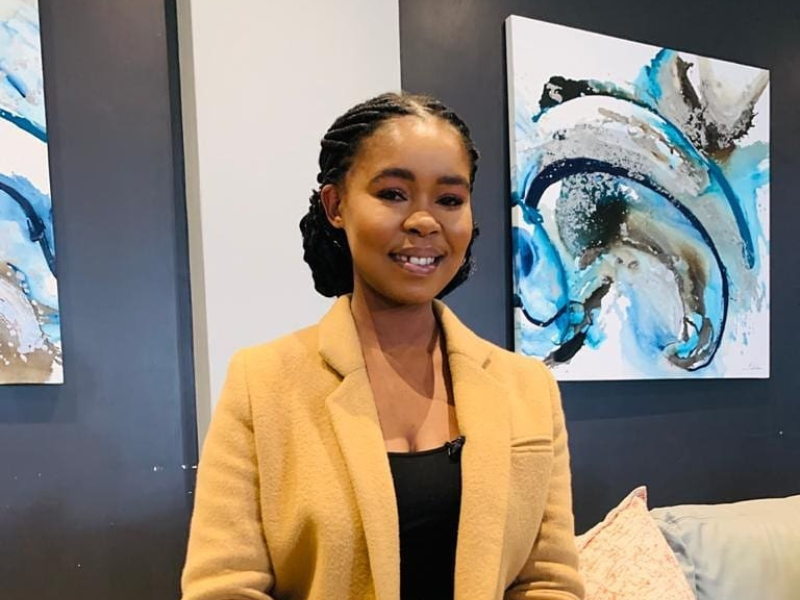 Zahara sitting on a couch